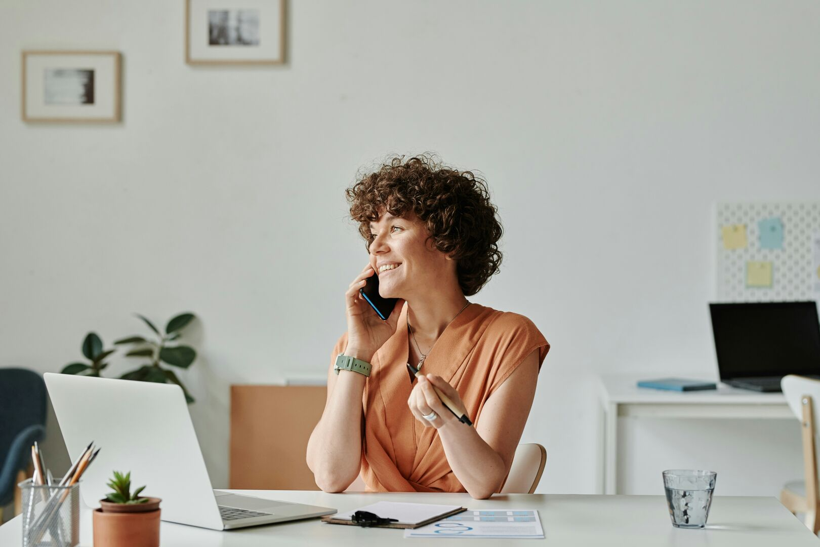 Woman on the phone in an office background