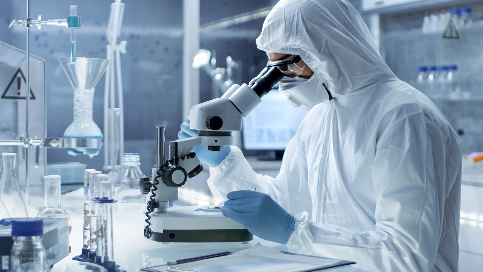 Person in laboratory using a microscope