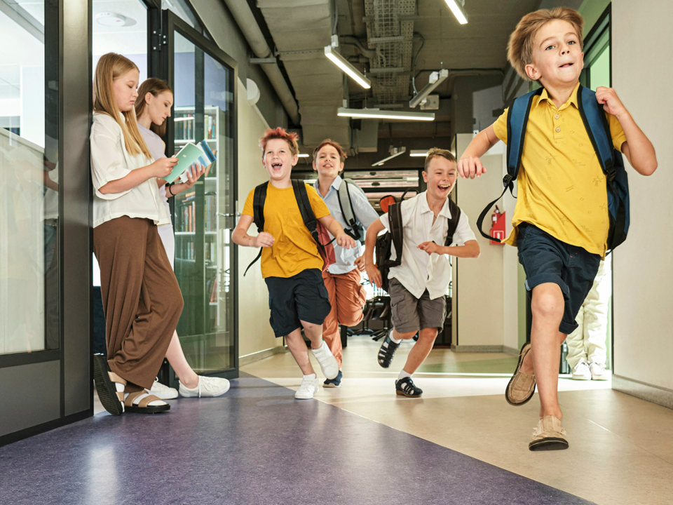 Children running in a school hallway