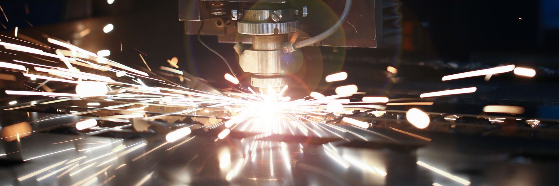 Laser metall cut cnc machine. Fly fire sparks background.
