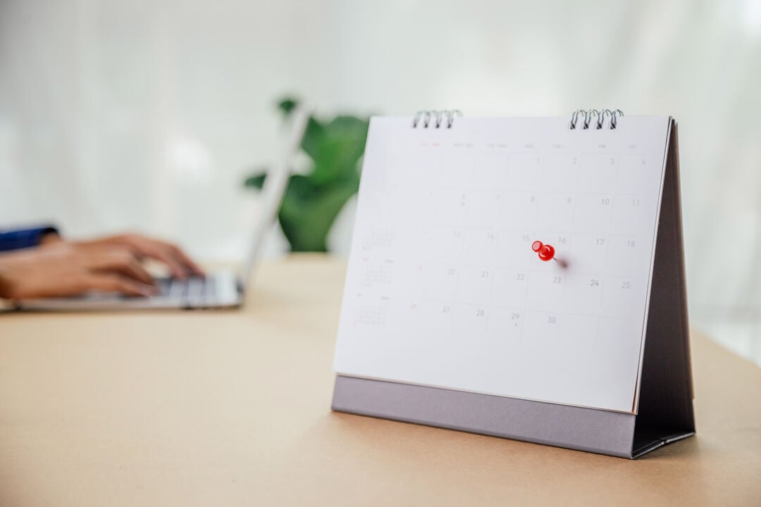 Calendar desk place on the table. Desktop Calender for Planner to plan agenda, timetable, appointment, organization, management each date, month, and year on wooden office table. Calendar Concept.