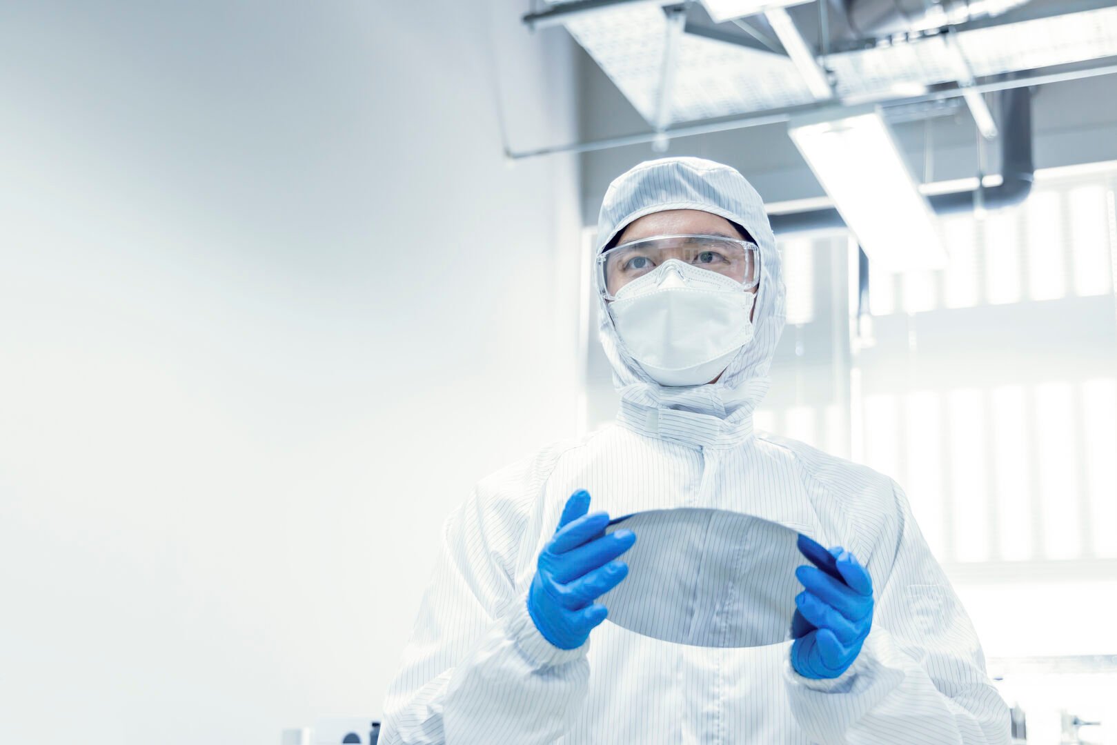Man in protective gear with semiconductor