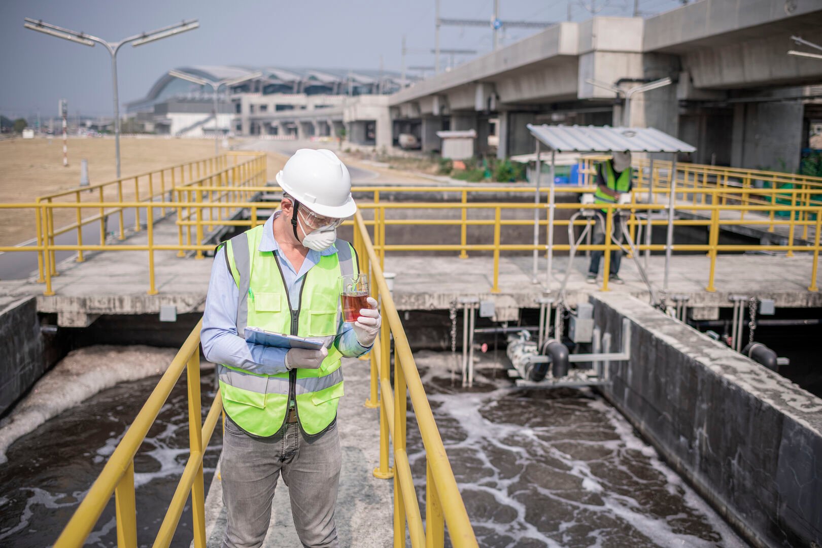 Waste water treatment facility with man checking water