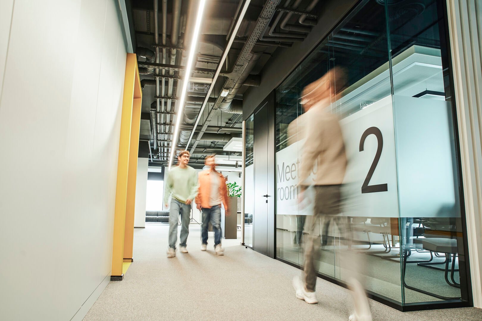 People walking through an office hallway