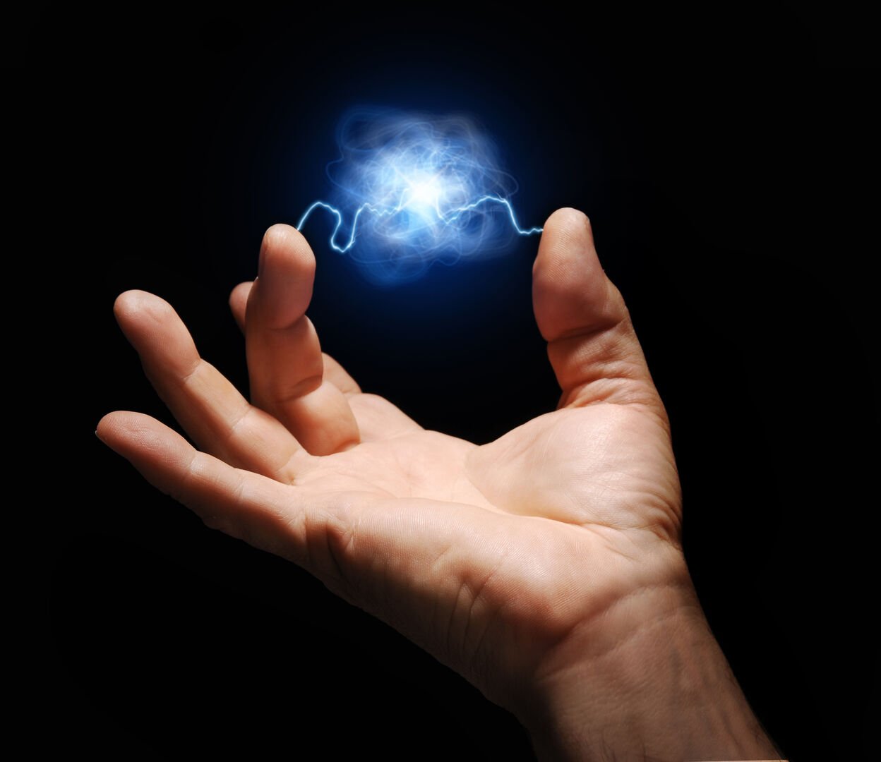 male hand with electricity arcing between thumb and middle finger with plasma ball suspended in the center