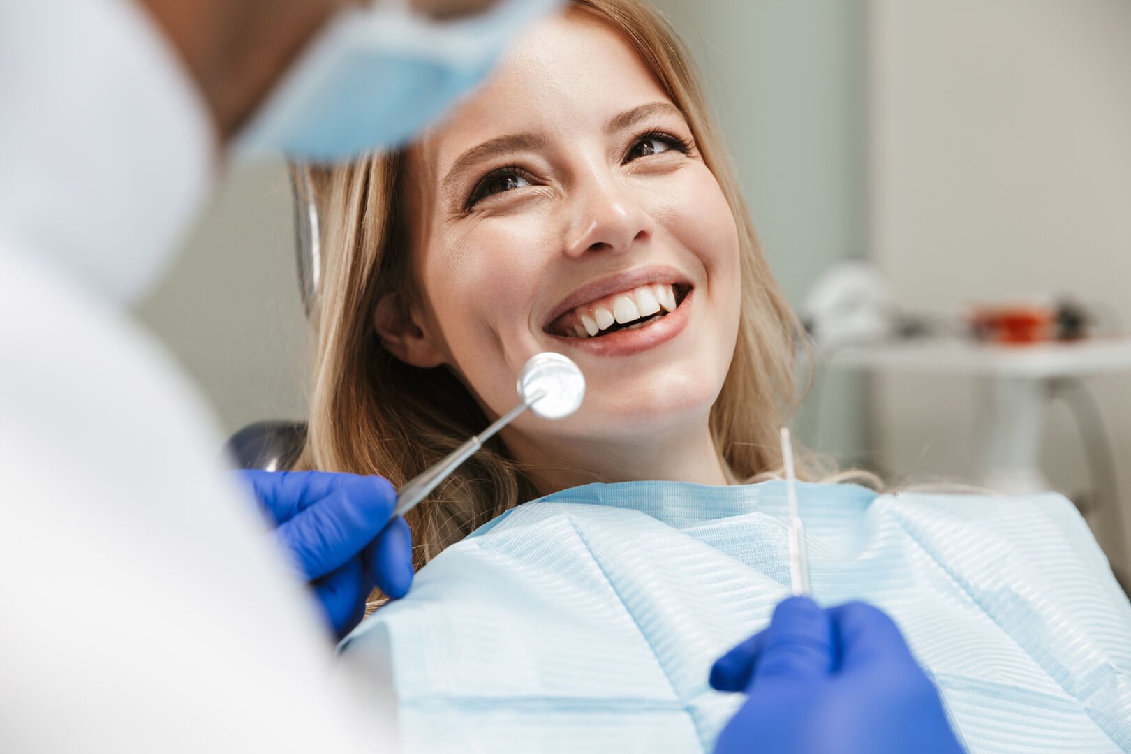 Image of pretty woman sitting in dental chair while professional doctor fixing her teeth, ADOBE LICENSE