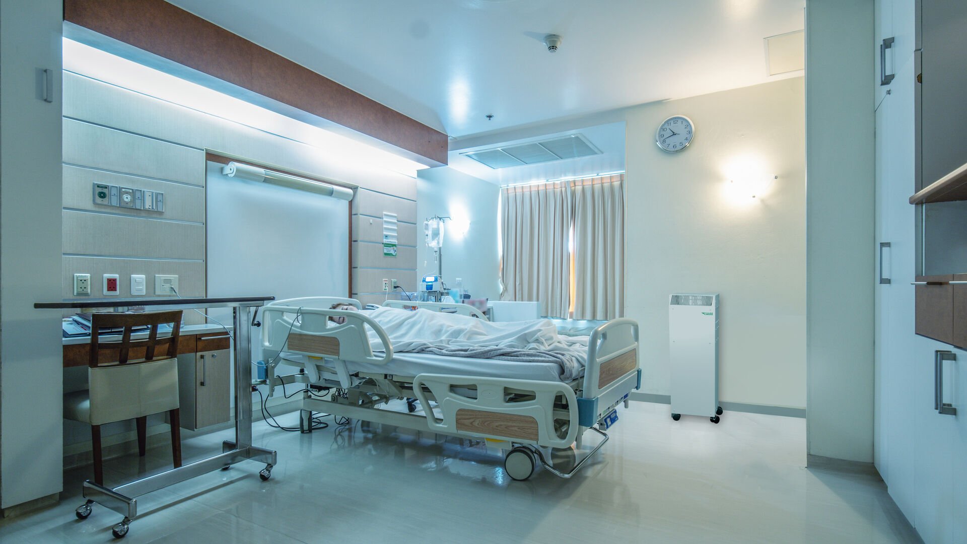 hospital recovery patient single room with fully furnished with a female patient with saline unit on bed
